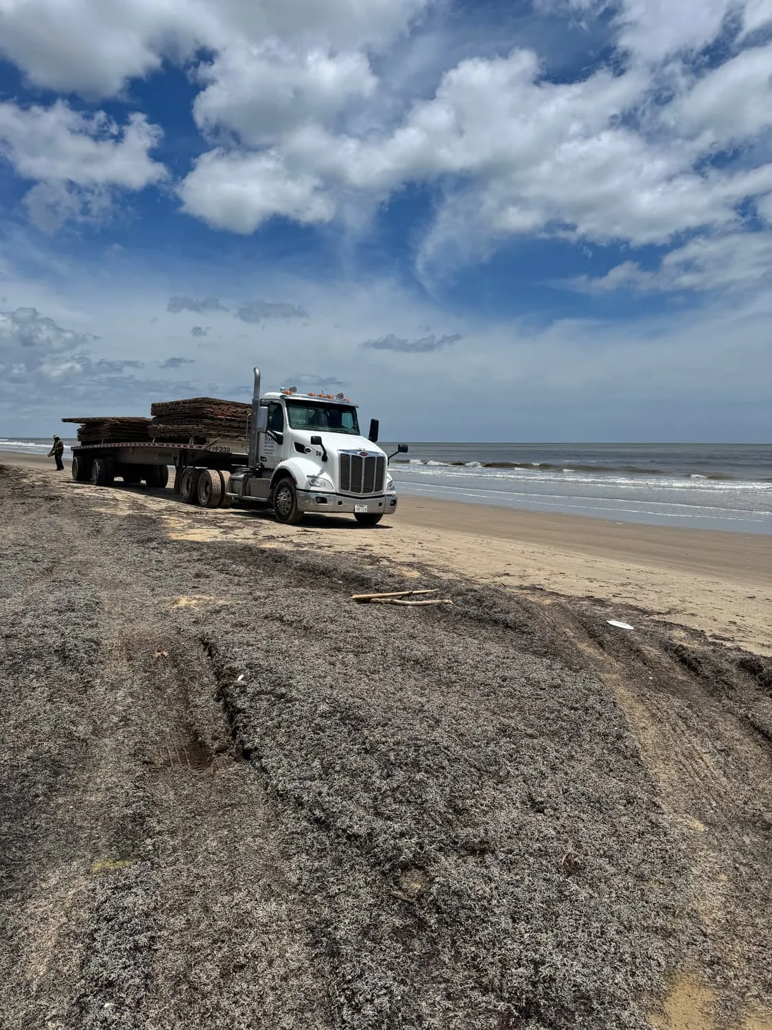 MDJ Services truck delivering mats on the sand at McFaddin Beach, TX