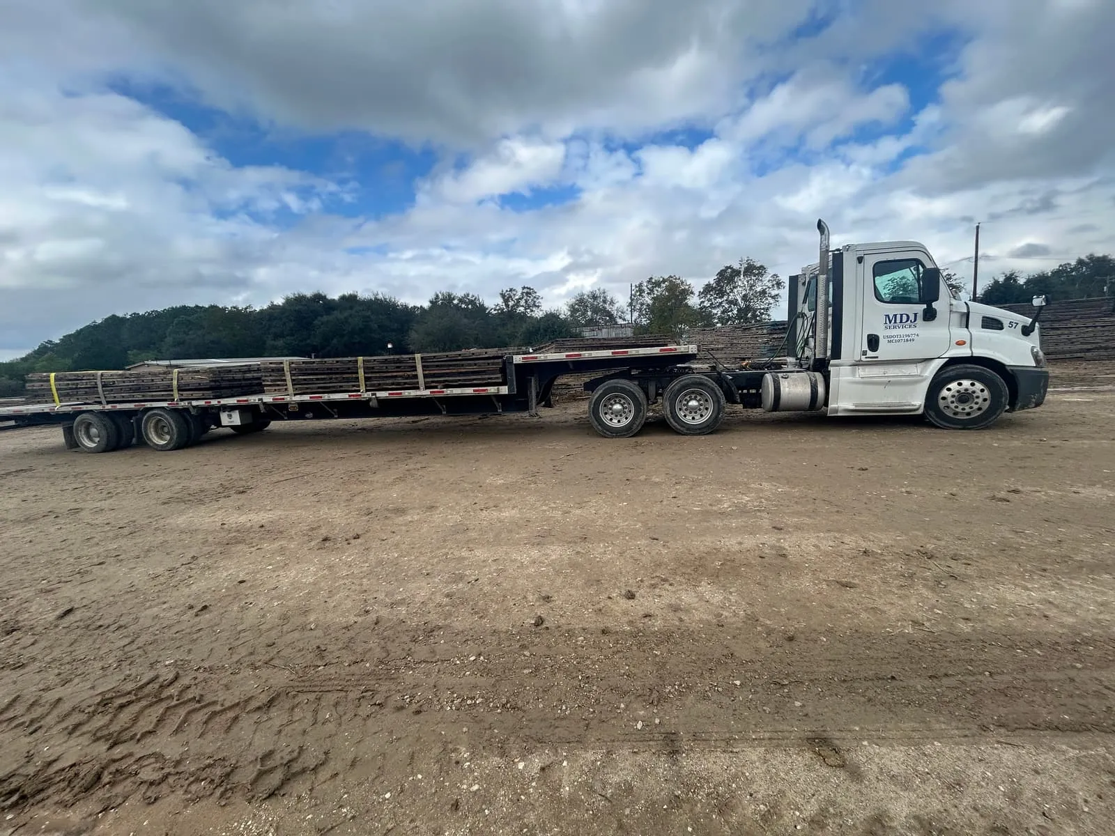 Crane mats strapped to an MDJ Services step deck trailer near Port Arthur, TX