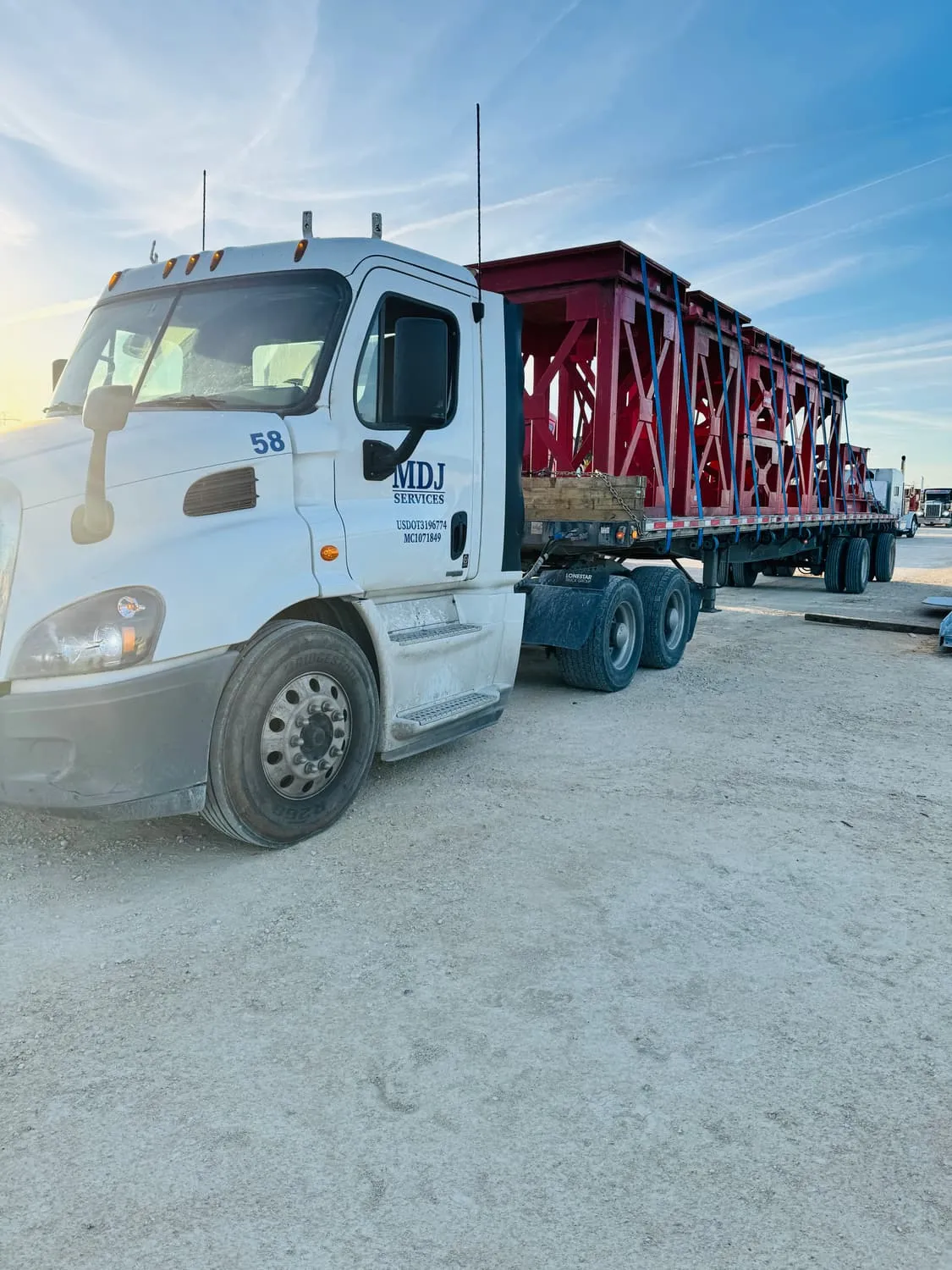 Fabricated crane support structures chained to an MDJ Services flatbed near Orange, TX