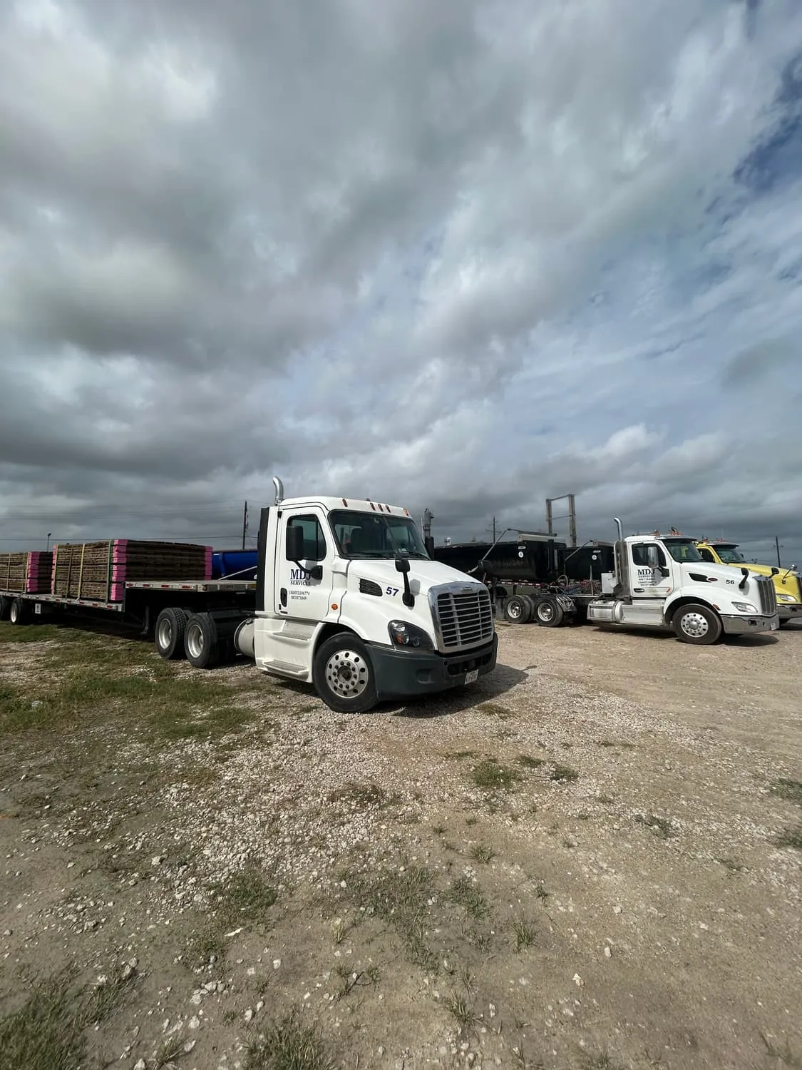 MDJ Services flatbed trucks staged at the company yard in Port Arthur, TX